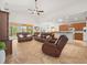 Spacious living room with high ceilings, tile flooring, and comfortable leather furniture at 4313 Heath Land Ln, Lake Wales, FL 33859