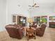 Cozy living room with leather seating, a fireplace and an entertainment center with a large TV at 4313 Heath Land Ln, Lake Wales, FL 33859