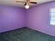 Simple bedroom with carpet, a ceiling fan, and a window with blinds offering ample natural light at 460 Pinehurst Ct, Winter Haven, FL 33884