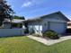 Inviting home featuring a light blue exterior, attached garage, and well-maintained front yard at 460 Pinehurst Ct, Winter Haven, FL 33884