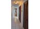 Hallway features tile floors and access to the bathroom as well as closet space with louvered doors at 460 Pinehurst Ct, Winter Haven, FL 33884