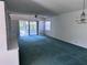 Open living room with bright lighting, ceiling fan, and sliding glass door access to lanai at 460 Pinehurst Ct, Winter Haven, FL 33884