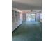 Spacious living room featuring a ceiling fan, sliding glass doors, and built-in shelving at 460 Pinehurst Ct, Winter Haven, FL 33884