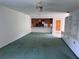 A large living room opens to the kitchen, featuring built in shelving and lots of natural light at 460 Pinehurst Ct, Winter Haven, FL 33884