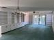 Bright living room with large built-in shelving, ceiling fan, and sliding glass doors at 460 Pinehurst Ct, Winter Haven, FL 33884
