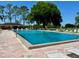 A large pool with lounge chairs and a building in the background on a sunny day at 460 Pinehurst Ct, Winter Haven, FL 33884