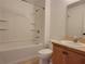 Bathroom featuring a shower-tub combo, toilet, and vanity with mirror at 4610 Yellow Bay Dr, Kissimmee, FL 34758
