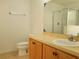 A bright bathroom features vanity with a sink, toilet, and glass-enclosed shower at 4610 Yellow Bay Dr, Kissimmee, FL 34758