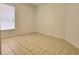An empty bedroom with tile flooring and a window with blinds at 4610 Yellow Bay Dr, Kissimmee, FL 34758