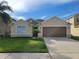 Charming single-story home with a well-maintained lawn and two-car garage at 4610 Yellow Bay Dr, Kissimmee, FL 34758