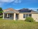 Backyard with screened-in porch and solar panels on the roof at 4610 Yellow Bay Dr, Kissimmee, FL 34758