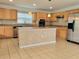 Spacious kitchen with an island, stainless steel appliances, and light brown cabinets at 4610 Yellow Bay Dr, Kissimmee, FL 34758