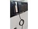 Close-up of a window air conditioner unit with an attached power cord at 4957 Old Lucerne Park Rd, Winter Haven, FL 33881