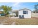 Exterior view of home with white siding and a covered carport at 4957 Old Lucerne Park Rd, Winter Haven, FL 33881