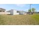 Exterior shot of white home with dark window frames and a lush green lawn at 4957 Old Lucerne Park Rd, Winter Haven, FL 33881