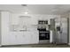 Modern kitchen with stainless steel appliances and white cabinets at 4957 Old Lucerne Park Rd, Winter Haven, FL 33881