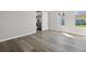 Open living room with wood-look floors and neutral walls at 4957 Old Lucerne Park Rd, Winter Haven, FL 33881