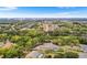 High aerial showcases this home, pool and yard, and surrounding trees in a residential neighborhood at 5020 Broadmore Dr, Auburndale, FL 33823