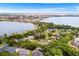 An aerial view of homes near a lake, with lush trees at 5020 Broadmore Dr, Auburndale, FL 33823