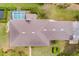 Aerial shot showcases the roof, pool, and surrounding greenery of this well-maintained property at 5020 Broadmore Dr, Auburndale, FL 33823