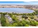 High aerial showcases homes, trees, and a large lake in a residential neighborhood at 5020 Broadmore Dr, Auburndale, FL 33823