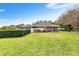The home has a well-maintained lawn and a screened-in porch, ideal for outdoor gatherings at 5020 Broadmore Dr, Auburndale, FL 33823