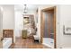 Neutral bathroom featuring a walk-in shower with a bench, tile flooring, and a window at 5020 Broadmore Dr, Auburndale, FL 33823