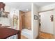 Cozy bathroom with tiled walls and floors, plus a shower and window for natural light at 5020 Broadmore Dr, Auburndale, FL 33823