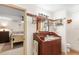 Bathroom featuring a vanity with decorative chairs, a window, and access to the main bedroom at 5020 Broadmore Dr, Auburndale, FL 33823