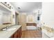 Bright bathroom featuring a modern vanity, a soaking tub, and a separate toilet at 5020 Broadmore Dr, Auburndale, FL 33823