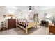Bedroom with a ceiling fan, a wood frame bed, and matching furniture pieces at 5020 Broadmore Dr, Auburndale, FL 33823