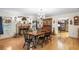Elegant dining room with hardwood floors, fireplace, traditional furnishings, and a vintage hutch at 5020 Broadmore Dr, Auburndale, FL 33823