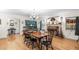 Inviting dining room with hardwood floors, a brick fireplace, and a decorative hutch at 5020 Broadmore Dr, Auburndale, FL 33823
