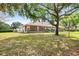 Spacious front yard frames this lovely home with a stone column porch, enhancing its inviting curb appeal at 5020 Broadmore Dr, Auburndale, FL 33823