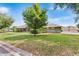 Beautifully landscaped lawn showcases this single-story house with mature trees and green shrubbery at 5020 Broadmore Dr, Auburndale, FL 33823