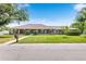 Charming single-story home with a welcoming front porch and well-manicured lawn, creating inviting curb appeal at 5020 Broadmore Dr, Auburndale, FL 33823