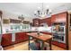 Stylish kitchen with custom cabinets, stainless steel appliances, and a functional center island at 5020 Broadmore Dr, Auburndale, FL 33823