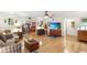 Bright and open living room with hardwood floors, connecting seamlessly to the dining area at 5020 Broadmore Dr, Auburndale, FL 33823
