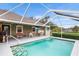 Inviting in-ground pool with patio seating, TV, and lovely landscaping at 5020 Broadmore Dr, Auburndale, FL 33823