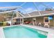 A screened pool area with an in-ground pool, outdoor seating, and a view of the home's exterior at 5020 Broadmore Dr, Auburndale, FL 33823