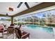 Screened-in pool area with seating for entertaining and well manicured landscaping at 5020 Broadmore Dr, Auburndale, FL 33823