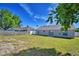 Backyard with a lawn, surrounded by a privacy fence and mature trees at 509 Heather Glen Dr, Winter Haven, FL 33884