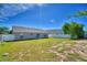 Spacious backyard featuring a lush lawn, privacy fence, and mature trees at 509 Heather Glen Dr, Winter Haven, FL 33884