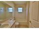 A well-lit bathroom features a shower-tub combination and neutral-toned walls and floors at 509 Heather Glen Dr, Winter Haven, FL 33884