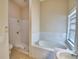 The bathroom features a tiled shower, a separate tub, and neutral walls, offering relaxation at 509 Heather Glen Dr, Winter Haven, FL 33884