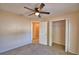 Bedroom with an open closet and doorway to another room, featuring neutral walls and carpet at 509 Heather Glen Dr, Winter Haven, FL 33884