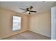 Bedroom with neutral carpeting, ceiling fan and a window providing natural light at 509 Heather Glen Dr, Winter Haven, FL 33884