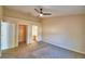 Carpeted bedroom offers a walk-in closet and a doorway leading to a bathroom with dual sinks at 509 Heather Glen Dr, Winter Haven, FL 33884