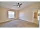 Cozy bedroom with neutral walls, carpet flooring, a window with blinds, and an ensuite bath at 509 Heather Glen Dr, Winter Haven, FL 33884