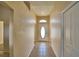 Inviting hallway with neutral-toned walls and tile flooring leading to a front door with decorative glass window at 509 Heather Glen Dr, Winter Haven, FL 33884